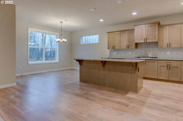 3012 S Nectarine, Cornelius, OR 97113 - kitchen featuring a sink, a chandelier, a breakfast bar area, decorative backsplash, and recessed lighting