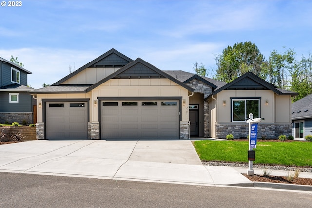 craftsman inspired home with a garage and a front lawn