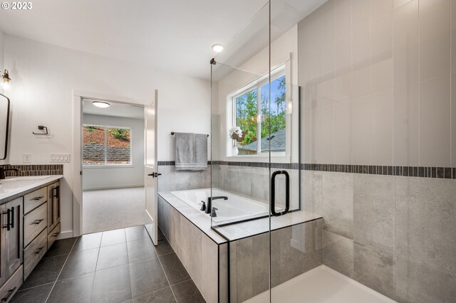 full bath with a bath, a stall shower, vanity, and tile patterned floors