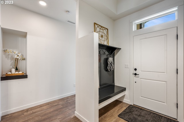 mudroom with wood finished floors, visible vents, and baseboards