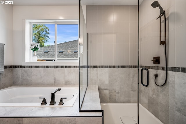 bathroom featuring a stall shower and a garden tub