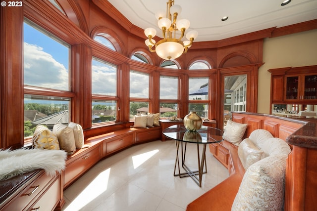 tiled living room featuring crown molding and a notable chandelier