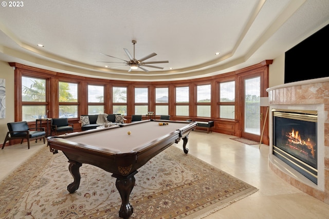 game room featuring a raised ceiling, plenty of natural light, billiards, and ceiling fan