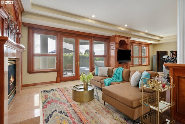 living room with a raised ceiling and light tile flooring