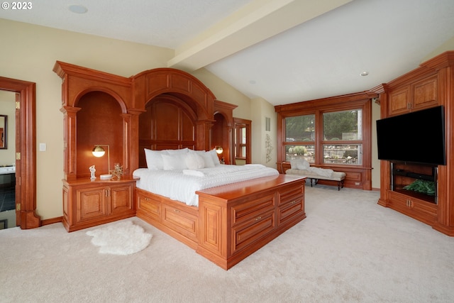 carpeted bedroom featuring lofted ceiling with beams