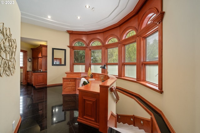 interior space featuring a wealth of natural light and dark tile flooring