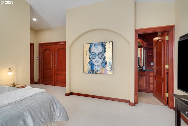 carpeted bedroom featuring ensuite bathroom