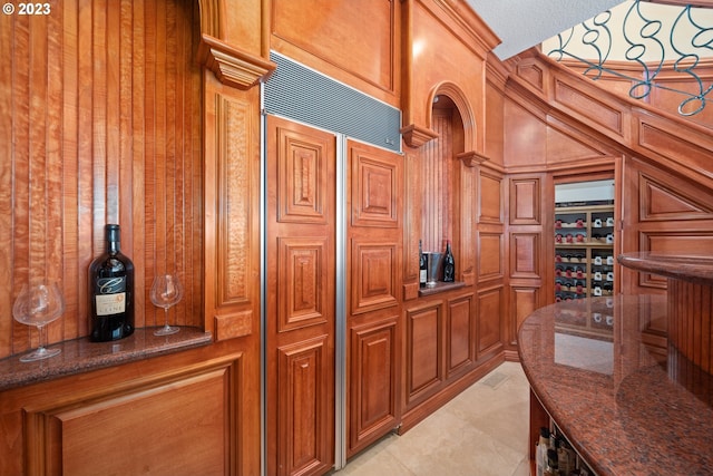 interior space featuring light tile floors and bar area