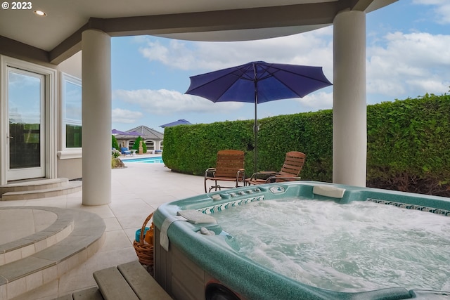 view of patio / terrace featuring an outdoor hot tub