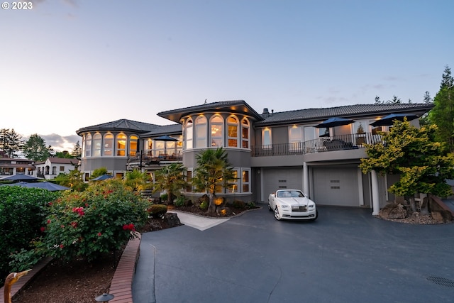 view of front of home featuring a balcony and a garage