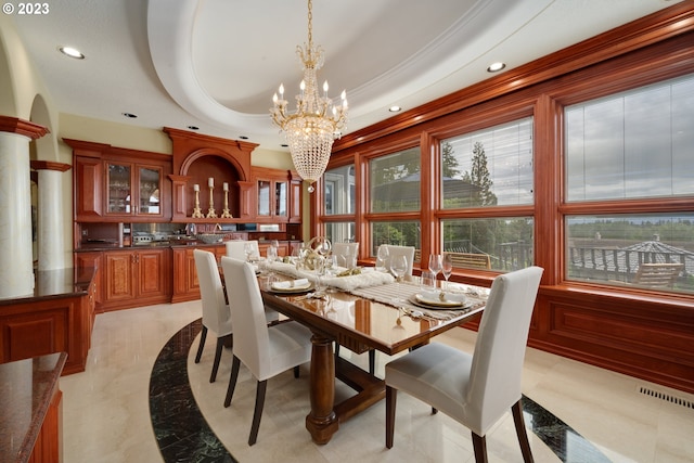 tiled dining area with a notable chandelier and a raised ceiling