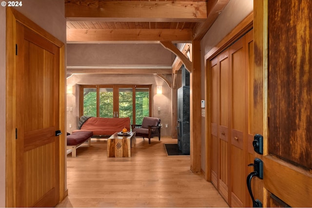 interior space featuring beam ceiling, wooden ceiling, and light wood-type flooring