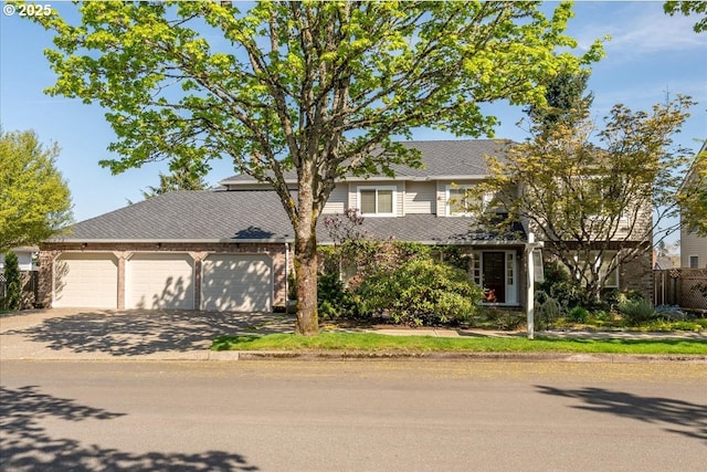 view of front of property with concrete driveway and an attached garage