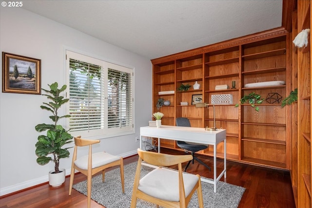 office with dark wood-type flooring, baseboards, and a textured ceiling