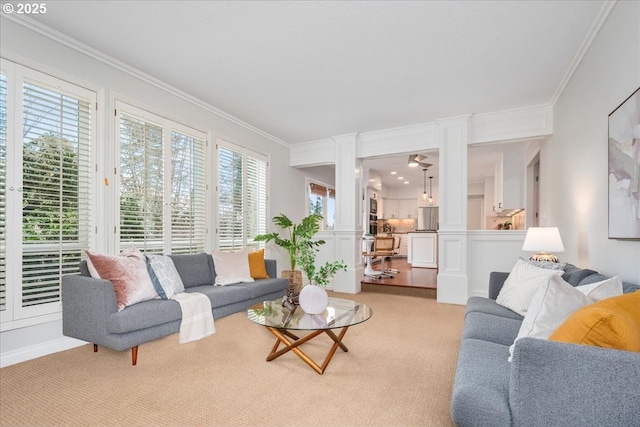 living room featuring plenty of natural light, light colored carpet, and ornamental molding