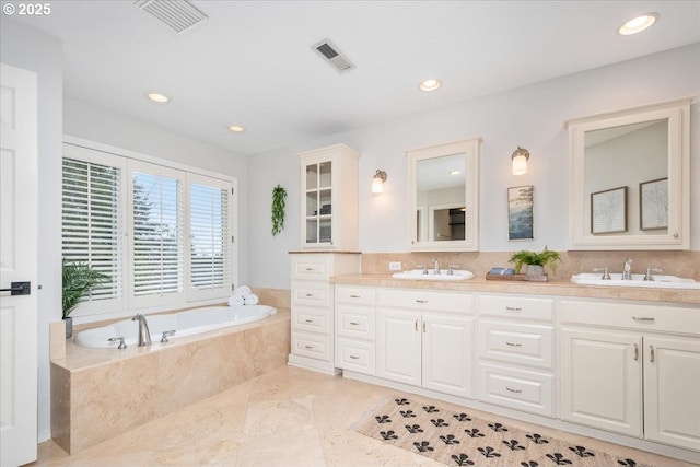 full bath with a bath, visible vents, and a sink