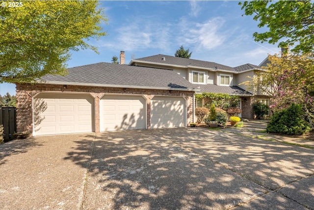 view of front facade with an attached garage, driveway, and brick siding