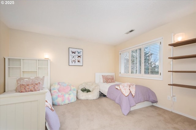 bedroom featuring baseboards, visible vents, and carpet floors