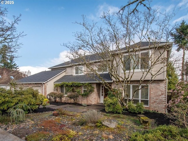 view of front of property with a garage and brick siding