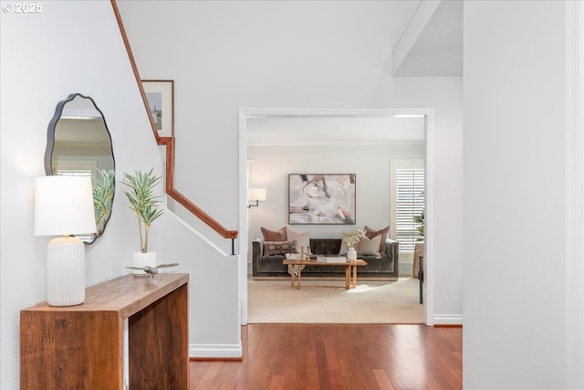 corridor featuring stairway, wood finished floors, and baseboards