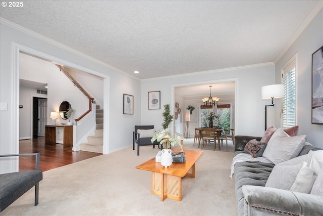 living area with a notable chandelier, stairway, carpet flooring, and crown molding