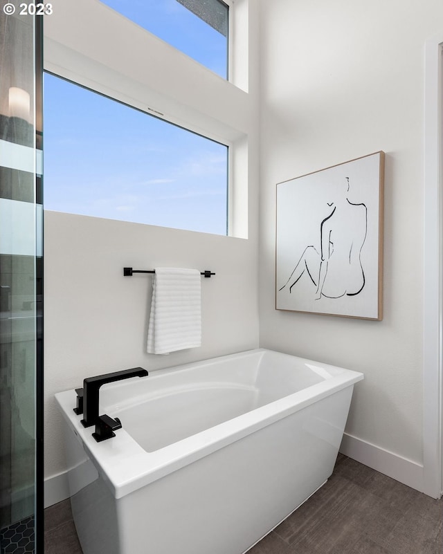 bathroom with hardwood / wood-style floors and a bathing tub