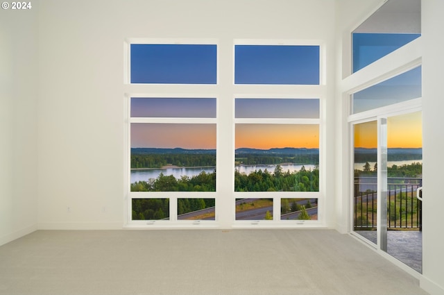 unfurnished sunroom featuring a water view