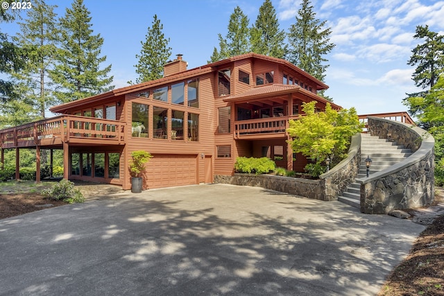 cabin featuring a wooden deck and a garage