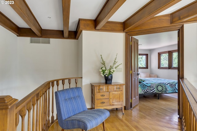 interior space featuring light hardwood / wood-style floors and beam ceiling