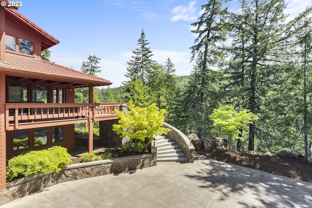 exterior space with a wooden deck and a patio area