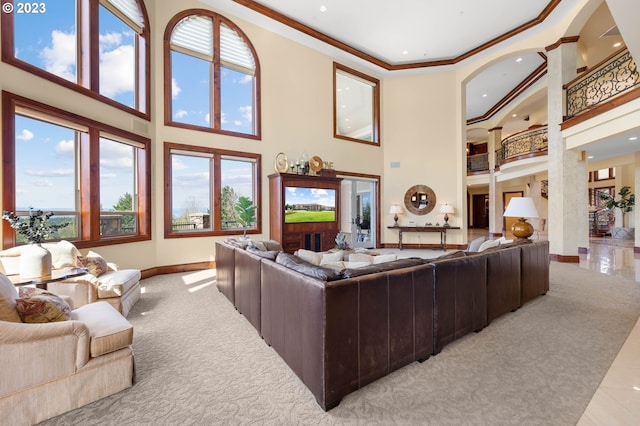 living room featuring decorative columns, ornamental molding, light tile floors, and a towering ceiling