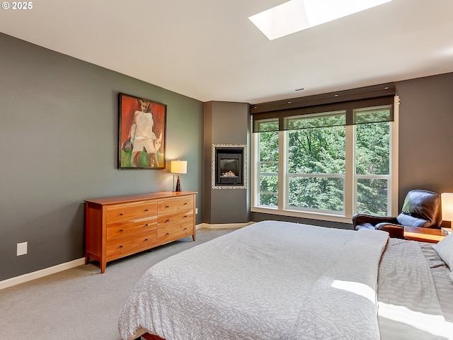 5912 SW Yamhill St, Portland, OR 97221 - carpeted bedroom with a skylight and baseboards