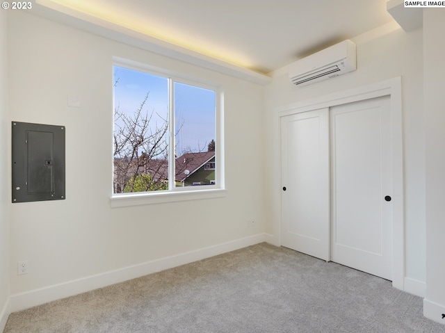 unfurnished bedroom featuring light carpet, electric panel, a wall unit AC, and a closet