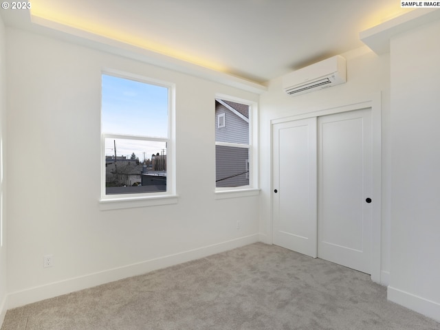 carpeted spare room featuring a wall unit AC