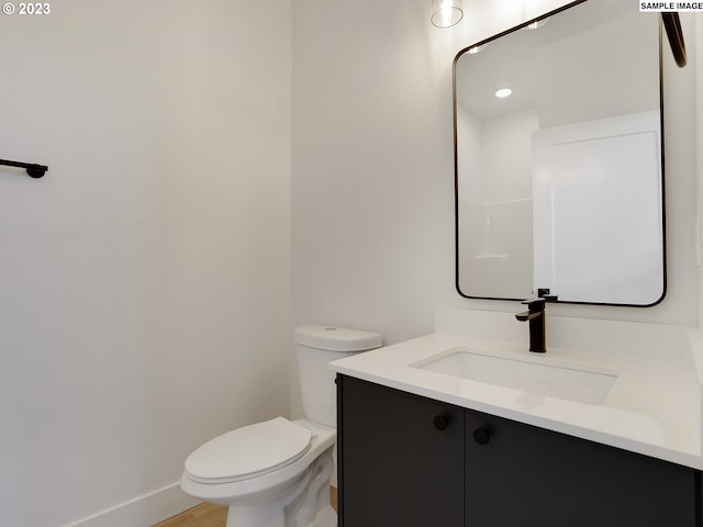 bathroom featuring hardwood / wood-style floors, vanity, and toilet