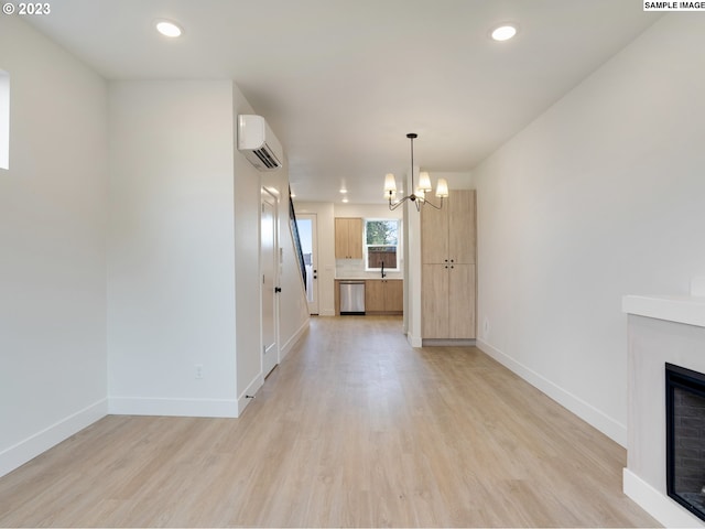 2321 N Lombard St Unit 5, Portland, OR 97217 - unfurnished living room featuring a chandelier, a wall mounted AC, light wood-style flooring, a fireplace, and recessed lighting