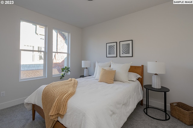 bedroom featuring dark colored carpet