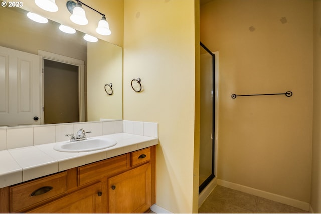 bathroom with tile floors, an enclosed shower, and vanity