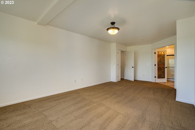 interior space featuring beam ceiling and light colored carpet