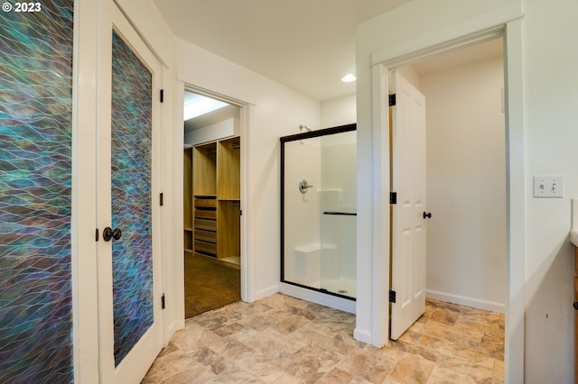 bathroom featuring tile flooring and a shower with shower door