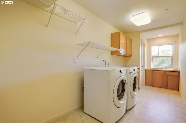 laundry room featuring cabinets, separate washer and dryer, and light tile flooring