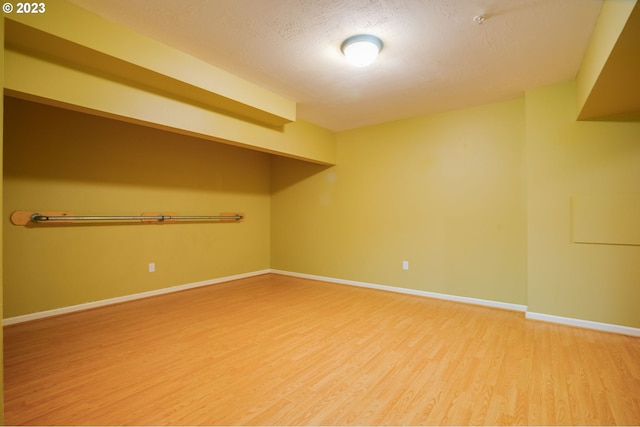 empty room featuring light hardwood / wood-style floors and a textured ceiling