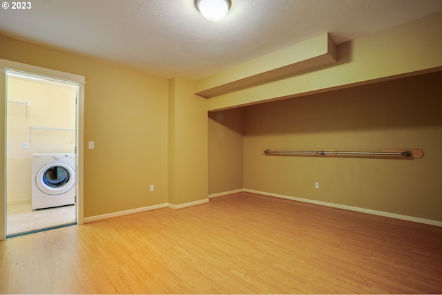 laundry area featuring light wood-type flooring and washer / dryer