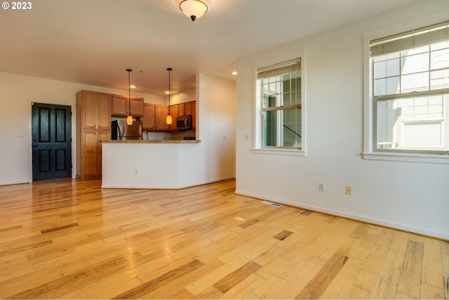 unfurnished living room featuring light hardwood / wood-style flooring