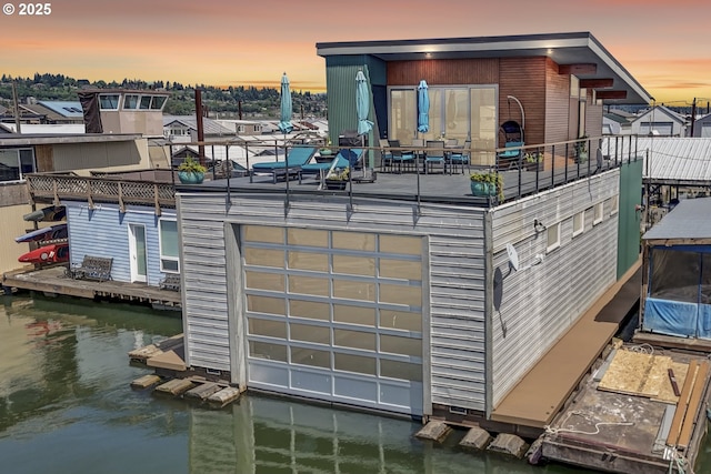 2901 NE Marine Dr Unit C-23, Portland, OR 97211 - back of house at dusk featuring a water view