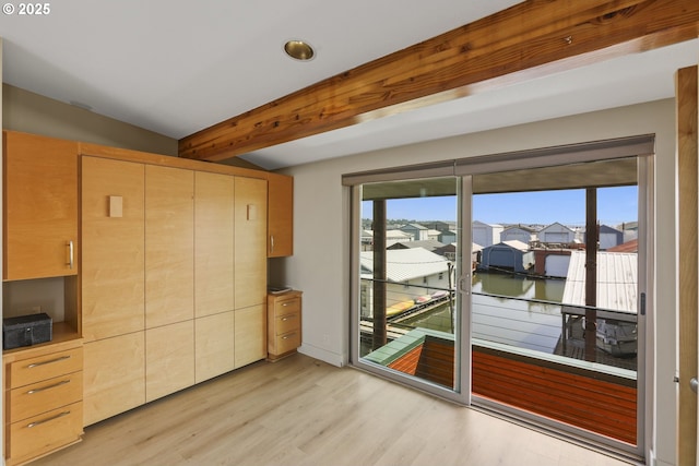 2901 NE Marine Dr Unit C-23, Portland, OR 97211 - unfurnished dining area featuring healthy amount of natural light, light wood-type flooring, beamed ceiling, a residential view, and a water view