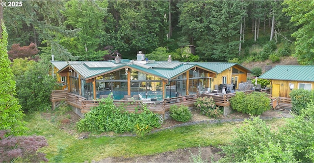 33423 Timber Ln, Eugene, OR 97405 - back of house with a wooden deck, an outdoor pool, and a metal roof