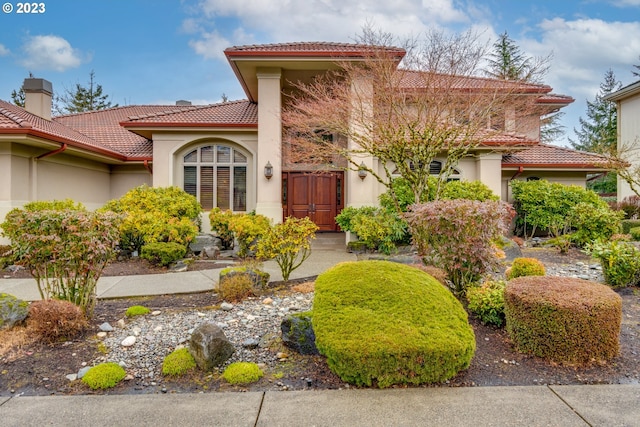 mediterranean / spanish-style home featuring a tile roof and stucco siding