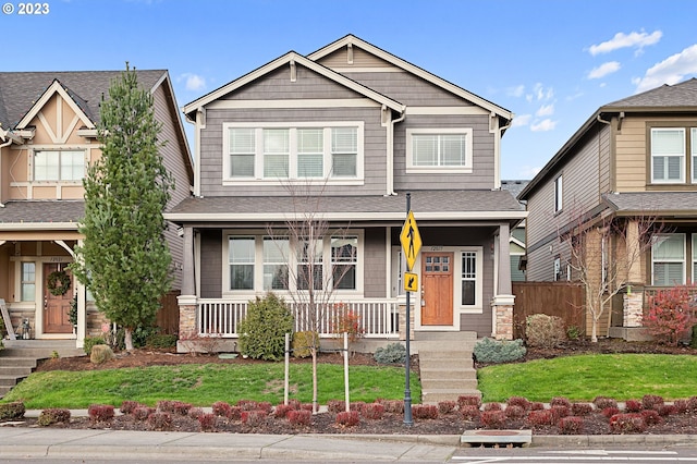 craftsman inspired home featuring a front yard and a porch