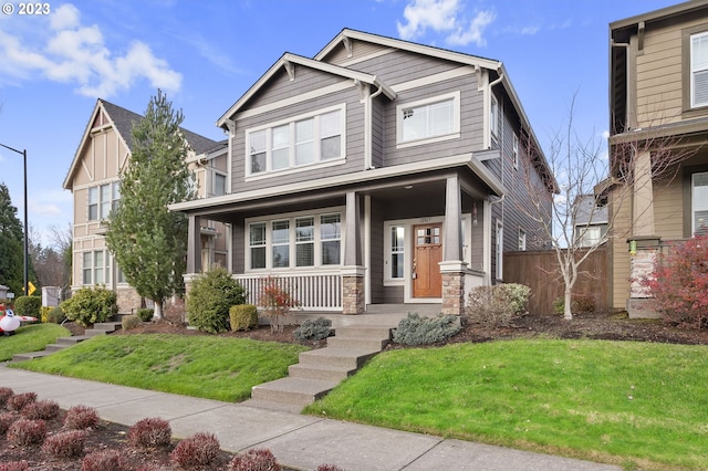 craftsman house with a front lawn and a porch